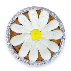 Daisy Cookie Cake decorated with white and yellow buttercream on a 7-inch deep dish chocolate chip cookie cake.