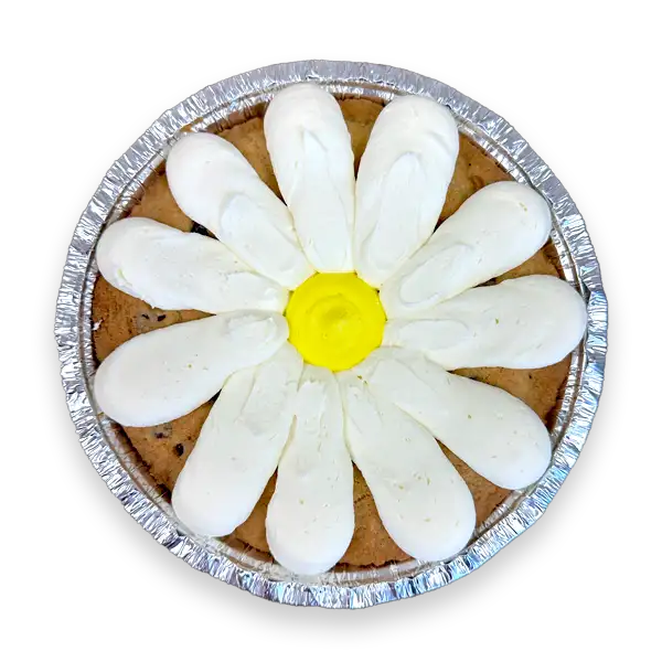 Daisy Cookie Cake decorated with white and yellow buttercream on a 7-inch deep dish chocolate chip cookie cake.