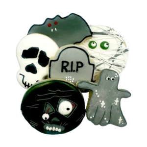 Assorted Halloween sugar cookies decorated with ghosts, skulls, tombstone, and mummy designs in colorful royal icing.