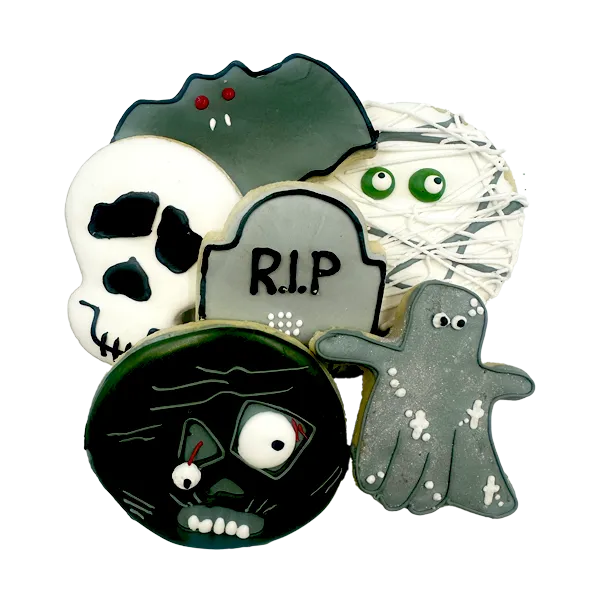 Assorted Halloween sugar cookies decorated with ghosts, skulls, tombstone, and mummy designs in colorful royal icing.