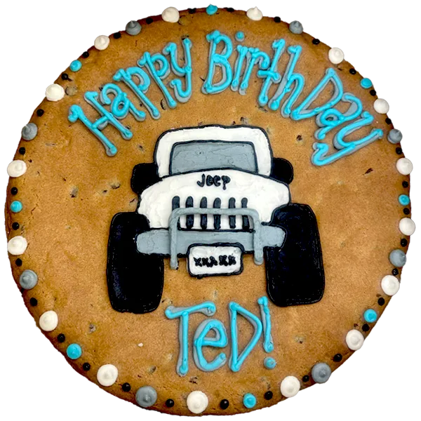 Giant chocolate chip flavored cookie cake decorated with a frosted 4x4 Jeep and text that reads "happy birthday Ted".