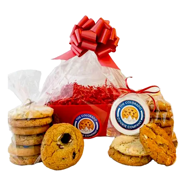 Cookie Market Box from The Colorado Cookie Company featuring a festive red gift basket wrapped in clear cellophane with a red bow, filled with fresh-baked cookies. The display includes stacks of assorted cookies and custom logo cookies, wrapped and tied with red ribbon, perfect for gifting or sharing.
