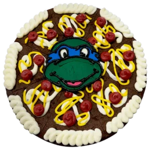 Giant chocolate, chocolate chip cookie cake decorated in a teenage mutant ninja turtle theme.
