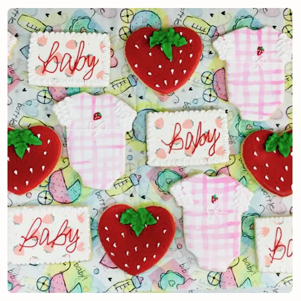 Strawberry themed baby shower decorated sugar cookies with baby onesies, strawberries, and personalized baby cookies