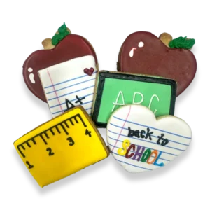 Hand-decorated Back to School sugar cookies with apples, notebooks, ruler, chalkboard, and school-themed royal icing
