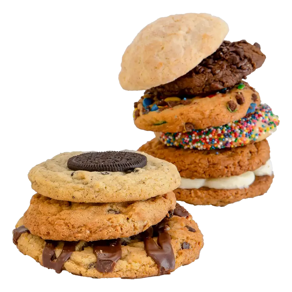 Stack of gourmet cookies in assorted flavors, including chocolate chip, sprinkle, snickerdoodle, and cookies topped with chocolate drizzle and an Oreo, showcasing The Colorado Cookie Company’s fresh-baked cookie variety.