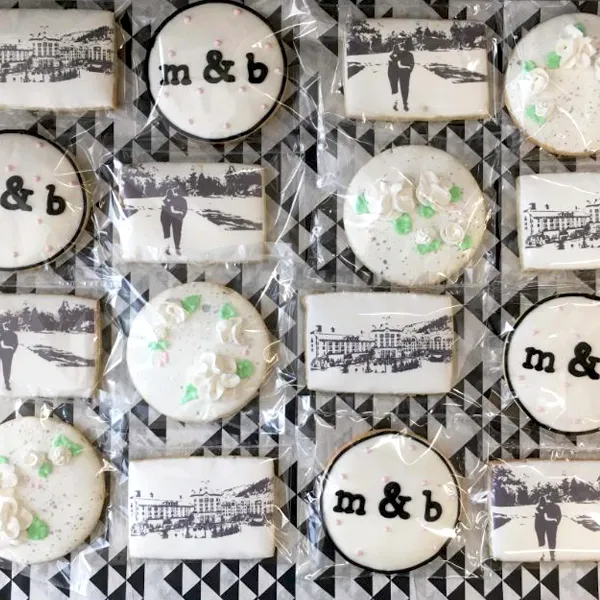Elegant custom decorated wedding cookies featuring monograms, edible photo cookies, and floral buttercream details