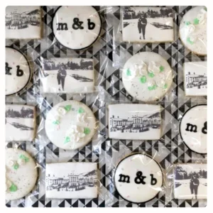 Elegant custom decorated wedding cookies featuring monograms, edible photo cookies, and floral buttercream details