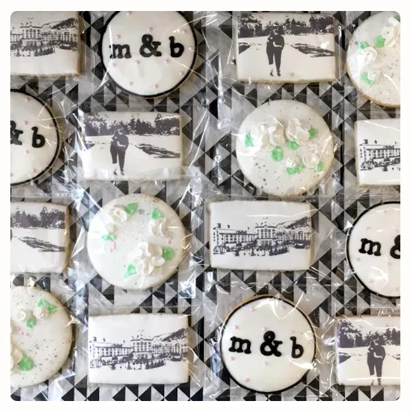 Elegant custom decorated wedding cookies featuring monograms, edible photo cookies, and floral buttercream details