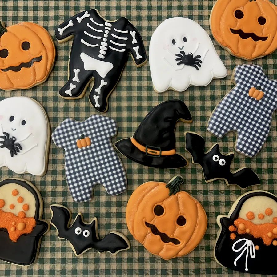 Custom Halloween decorated cookies with pumpkins, ghosts, skeletons, bats and witch hats.