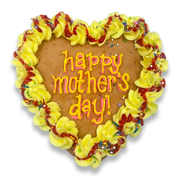Heart-shaped Mother's Day cookie cake decorated with yellow buttercream rosettes, colorful sprinkles, and a hand-piped "happy mother's day!" message in pink and orange lettering.