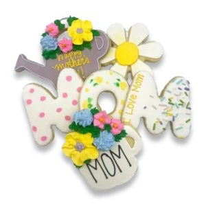 Hand-decorated Mother's Day sugar cookies with royal icing, featuring MOM letter cookies, a floral watering can, a daisy, and a flower pot cookie with pastel pink, yellow, and blue buttercream flowers, from The Colorado Cookie Company in Lakewood, Colorado.