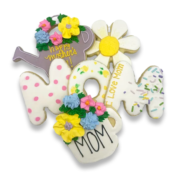 Hand-decorated Mother's Day sugar cookies with royal icing, featuring MOM letter cookies, a floral watering can, a daisy, and a flower pot cookie with pastel pink, yellow, and blue buttercream flowers, from The Colorado Cookie Company in Lakewood, Colorado.